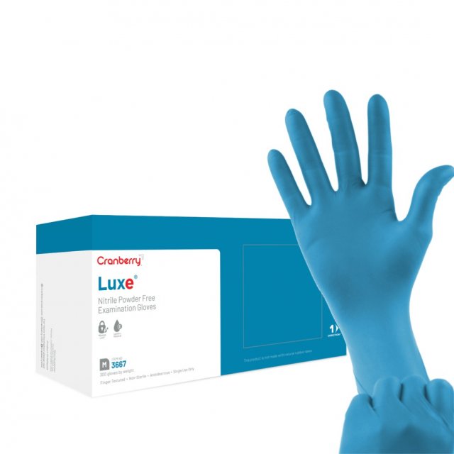 Cranberry LUXE nitrile exam gloves box held in gloved hands (manufacturer render)